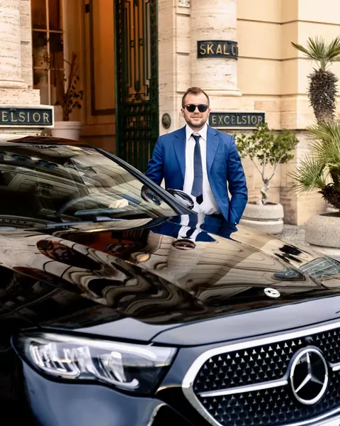 Andrea Cerrato, founder of Cerrato Limo, in front of Excelsior Hotel Naples